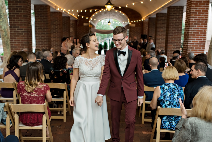 A bride and groom recess down the isle after getting married.